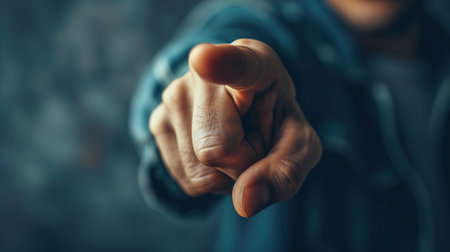 Close-up of a Caucasian unrecognizable man hand pointing with a finger at camera, gesture.の素材