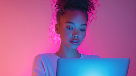 Woman holding a laptop in her hands, focused and enthusiastic working with the device on an online course or training program. Banner with copy space.の素材