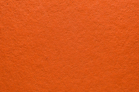 Rough texture of orange paper with fibers, macro photography. Close-up paper background top view