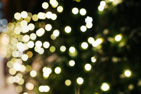 Christmas lights abstract background defocused, decorated with glowing garland tree at night. Blurred xmas festive backdrop, copy space.の写真素材