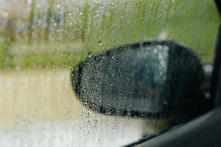 Wet window of car, drops of water on glass after rain, view from inside interior of vehicle....