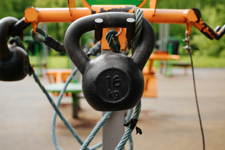 Outdoor sports ground with set of weights for weightlifting training in park, outdoors. Selective...