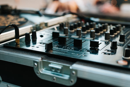 DJ set mixing console close-up outdoors. Selective soft focus.