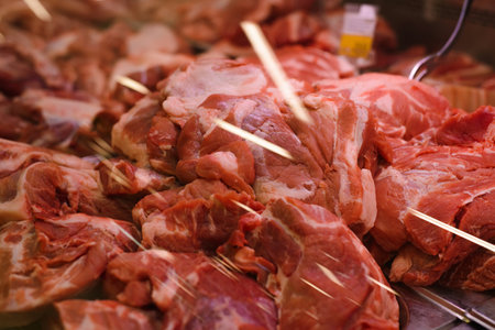 Pieces of raw meat lying on the counter for sale on showcase in a store. Close-up, selective focus.の写真素材