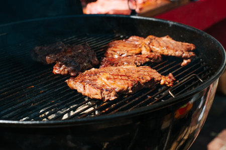 Top fillet steaks are grilled outdoors. Close-up of cooked meat, selective focus.の写真素材