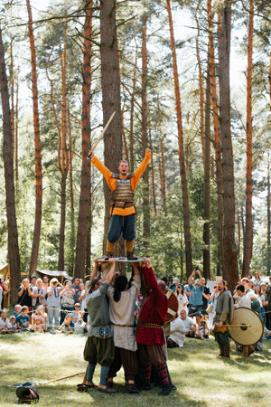 Vikings raised on the shield the winner of the battle. Festival of medieval ethnic culture and outdoor reconstruction. Smolensk, Russia 08/13/2022.の写真素材