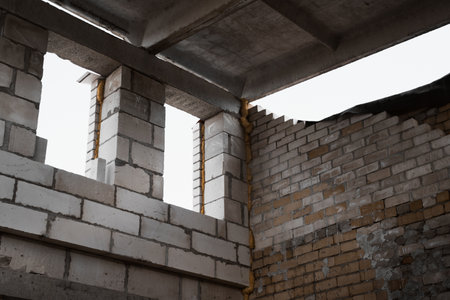 Construction site. Under construction garage made of bricks and concrete blocks, view inside. Window...