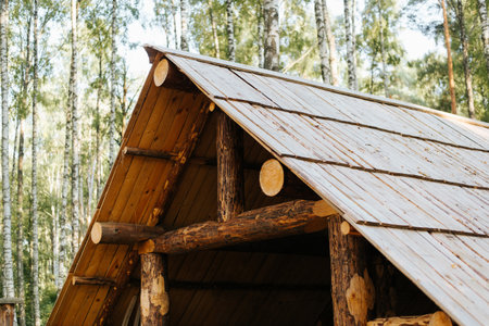 The structure of a wooden roof from a log house, exterior. Ancient architecture.の写真素材