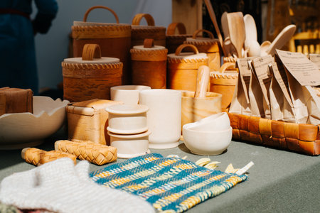 Homemade wooden utensils and vintage wood products are sold outdoors. Close-up, selective focus in...
