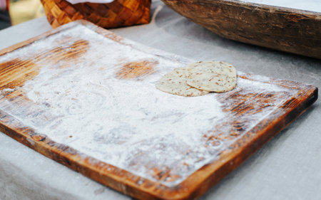 Tortillas with seeds in flour outdoors. Cooking a traditional old dish.