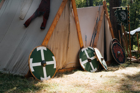 Military camp in the forest. Tents, shields and spears outdoors on a summer day.