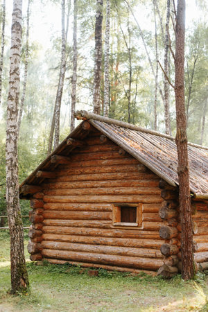 The exterior is a rustic wooden log house outdoors. Vertical view.の写真素材