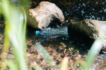 Environmental pollution problem concept. Used plastic bottle in the outdoors.の写真素材