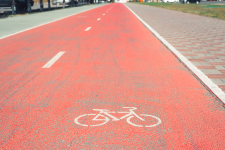 Dedicated bike lane with painted bike sign on rubber red surface.の写真素材
