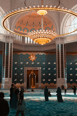 Large beautiful prayer hall, chandelier and decorated wall in the mosque, interior. Central mosque of Astana inside. Kazakhstan, Astana 03.10.2022.の写真素材