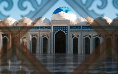 Close-up of a beautiful mosque, houses, arches and entrance door view through stained glass.の写真素材