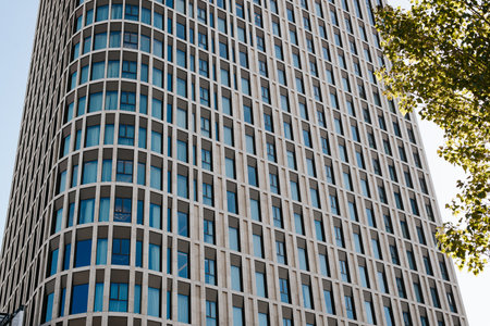 Multi-apartment high-rise residential building with round corners exterior, close-up.