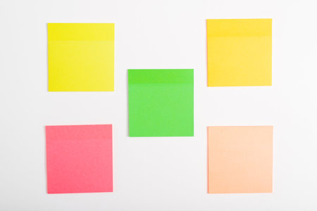 Five self-adhesive multi-colored stickers reminder mockup on a white surface.の写真素材