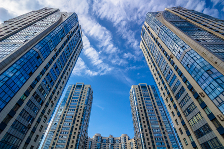 Looking up at round residential building with cloudy skyのeditorial素材
