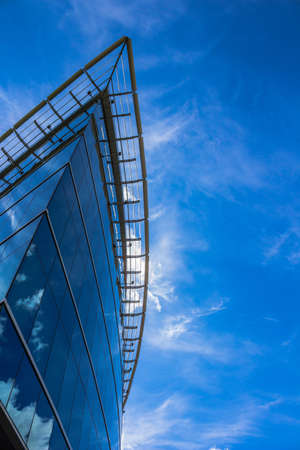 Blue glass building reflecting blue skyのeditorial素材