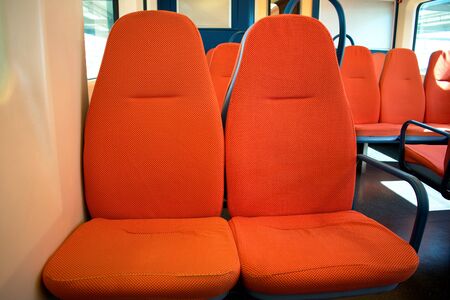 Orange train cabin with orange seatsの写真素材