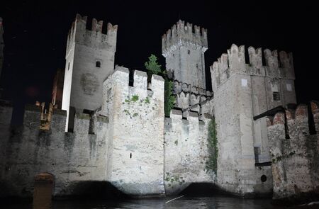 Wall of Sirmione on Lake Garda illuminated at nightのeditorial素材