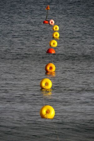 Yellow buoys wire in the blue sea of Mandriola (Sardinia - Italy)
