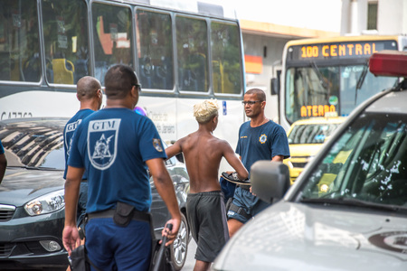RIO DE JANEIRO, BRAZIL - DECEMBER 30, 2016: Policemen making arrest of criminals and leading them to police cars at Avenida Princesa Isabel during preparation Copacabana to New Year 2017 celebrationのeditorial素材