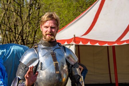 MOSCOW, RUSSIA - APRIL 30, 2017: Participant of international knight festival Tournament of St. George at the Kolomenskoye museum-reserve on the background of the tentのeditorial素材