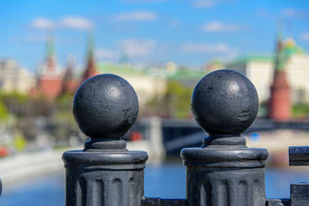 Two decorative fence spearheads on the background of blury Kremlin and Moscow river in the historical centre of Moscow cityの写真素材