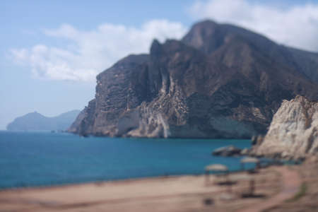 View of the sea and mountains from the beach in the summer.の写真素材