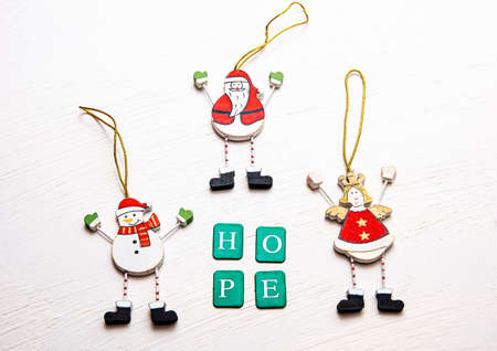 Flat lay of Christmas ornaments on a table with words of hope