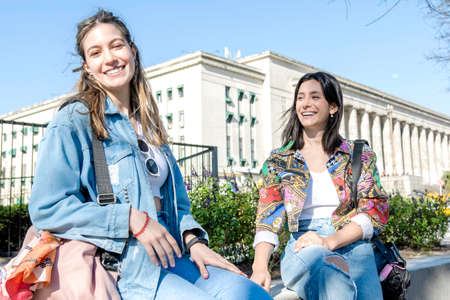 two young women passing through town having a lot of fun