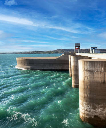 high voltage towers on a hydroelectric dam to distribute electricity in patagoniaの写真素材