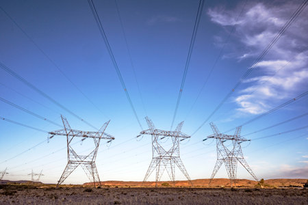 high voltage towers on a hydroelectric dam to distribute electricity in patagonia