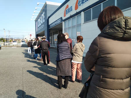Fuji City, Shizuoka Prefecture, Japan - April 4, 2020: Queue of people to buy mask for protection...