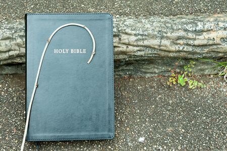 Holy Bible with small wooden staff on top. Background with stair step. Outdoors. Copy space. Horizontal shot.の写真素材