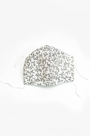 Floral pattern (black and white color) DIY fabric face mask for protection against coronavirus (COVID-19) and other infectious diseases. Isolated on white background. Copy space. Vertical shot.の写真素材