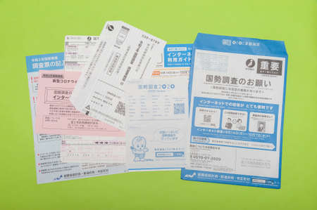 Fuji City, Shizuoka-Ken, Japan - October 4, 2020: Questionnaire, forms and envelopes related to the 2020 Census in Japan. Isolated on green background.のeditorial素材