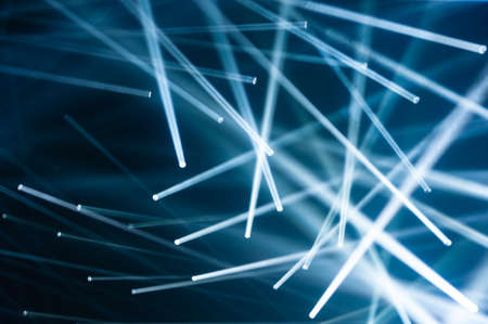 White LED light beams projected in various directions. Dark blue background.の写真素材