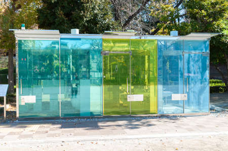 Shibuya City, Tokyo, Japan - November 23, 2020: Transparent public toilet located at Haru-No-Ogawa...