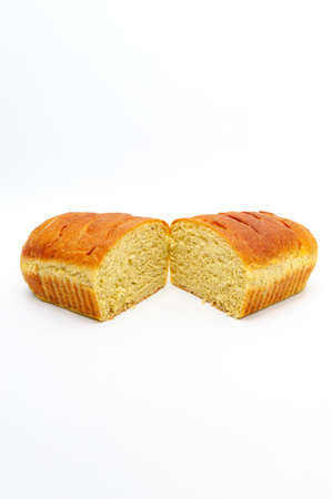 Delicious homemade spiced bread cut in half isolated on white background. Vertical shot.