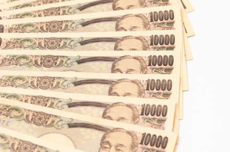 10,000 yen stack close up isolated on white background.