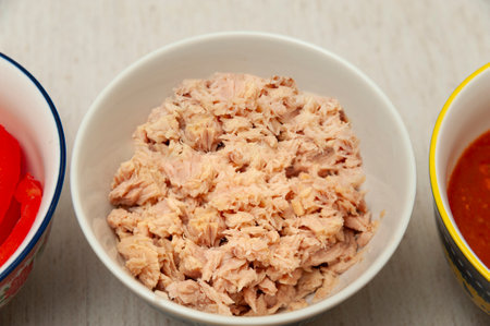 Tuna in bowl in top view isolated on light background.の写真素材