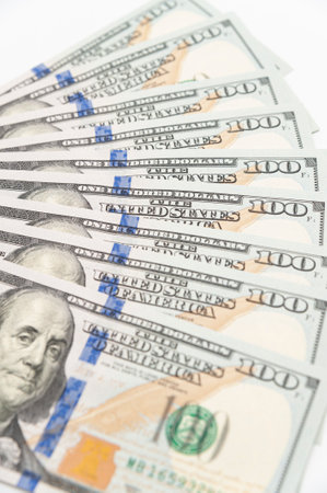Nine hundred dollar cash banknotes in close-up isolated on white background.