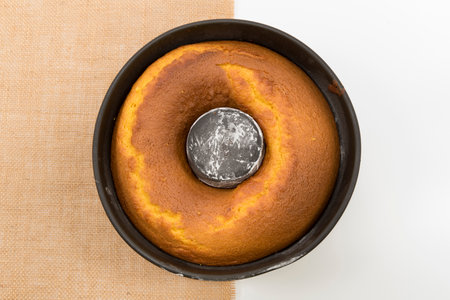 Traditional and delicious homemade Brazilian carrot cake in the pan. Isolated on jute and white background.の写真素材