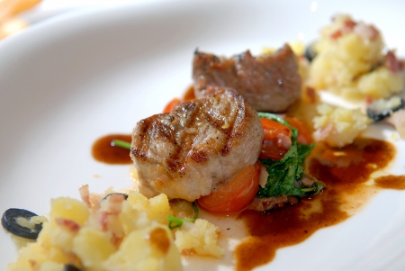 Pork medallions with a pounded potatoの写真素材