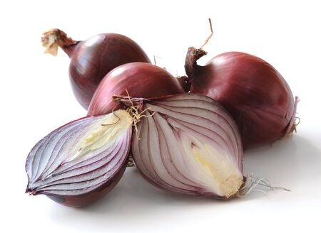 Several red onions on a white background.  の写真素材