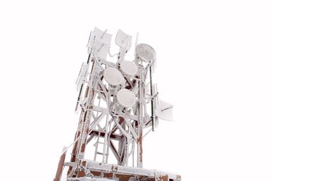 satellite dishes in a hoarfrost and to snow on a telecommunication towerの写真素材