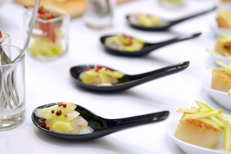 scallops in the spoon on the buffet tableの写真素材